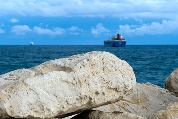 White rocks, blue sea, sky and ships on horizon