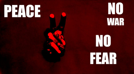 Male hand with the two finger. Body language concept with hole in red paper wall. Hand Peace Sign....