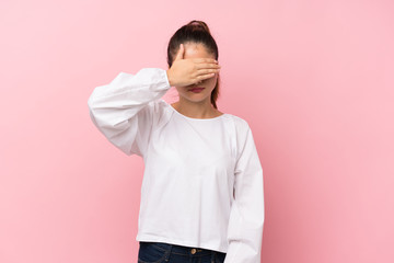 Young brunette girl over isolated pink background covering eyes by hands. Do not want to see...