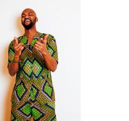 portrait of young handsome african man wearing bright green national costume smiling gesturing, entertainment stuff