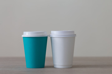 Food. Multi colored paper cup cappuccino in beige background