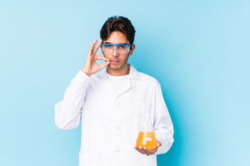 Young cientific caucasian man isolated with fingers on lips keeping a secret.