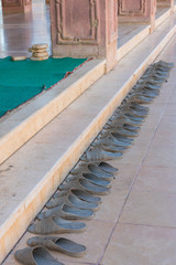 Shoes outside the door of a mosque in Sharm El Sheikh. Islamic faith concept. vertical photo