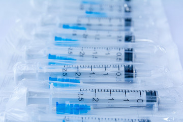 Medical syringes in a package. Medical syringes in packaging as an abstract background.