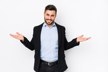 Young caucasian business man against a white background isolated showing a welcome expression.