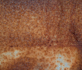 iron texture of rusty sheet with remains of blue paint
