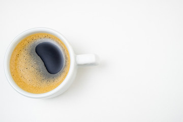 Coffee cup espresso on white kitchen table. Coffee cup closeup. Morning, breakfast, energy, coffee break concept. Top view