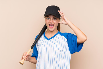 Young girl playing baseball over isolated background with surprise and shocked facial expression