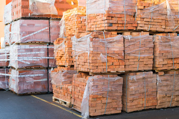 clay brick stored for building construction. Industrial production of bricks. brick production line in factory, stacked bricks