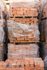 clay brick stored for building construction. Industrial production of bricks. brick production line in factory, stacked bricks. vertical photo