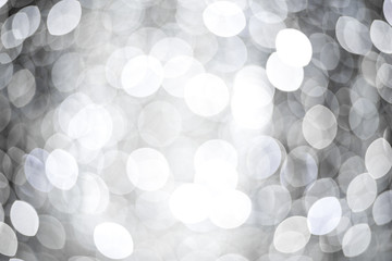 Abstract background with silver and white bokeh. Festive concept.
