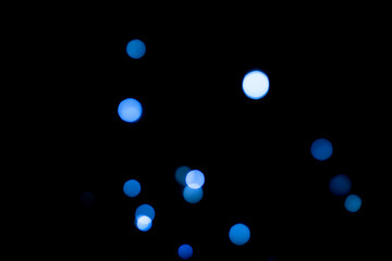 Black abstract background with blue bokeh. Color of year 2020.