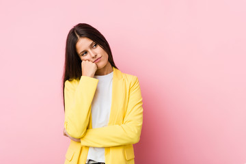 Fototapeta premium Young business woman who feels sad and pensive, looking at copy space.