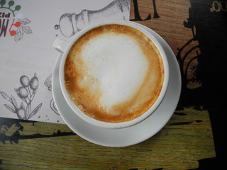 cappuccino  in a white cup on a saucer