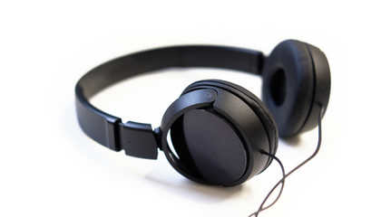 Obraz na płótnie Canvas Classic black wired headphones on white background. Minimalistic music concept