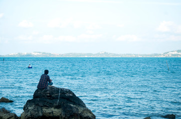 relaxing on the rock by the sea