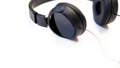 Classic black wired headphones on white background. Minimalistic music concept