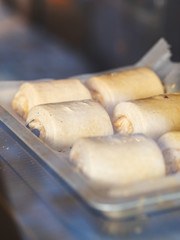 Cooking delicious pastries. blank rolls with chocolate. puff pastry. cover with egg yolk. A small bakery. lifestyle.