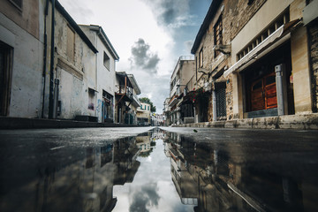 street in limassol after rain with shops