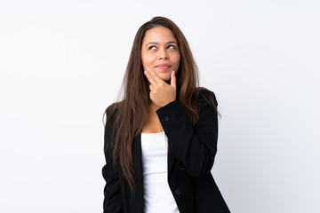 Fototapeta premium Young Brazilian girl with blazer over isolated white background thinking an idea