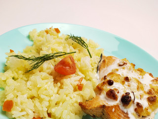 Grilled salmon with white rice on a plate on a white background. fish fillet with rice close up.