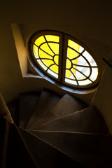 The architecture of the old city of Prague. Unusually round staircase window in the entrance hall
