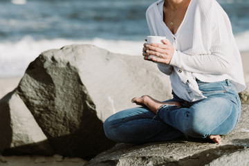 Woman Sitting By The Ocean Holding A Cup, Relaxed Yoga Lifestyle Concept