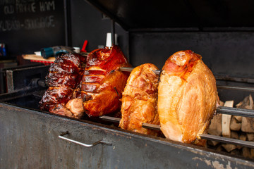 Fototapeta premium Large juicy pieces of meat are grilled. Street food in the square in the center of the old city