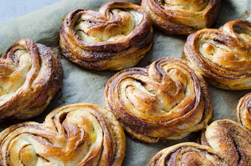 Baked fresh fragrant cinnamon buns. Traditional homemade pastries.