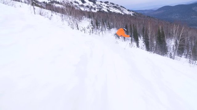 Extreme freeride downhill skiing in a snow covered forest