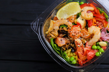 Tasty salad with seafood on wooden table, close up
