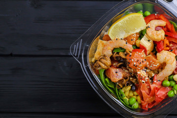 Tasty salad with seafood on wooden table, close up