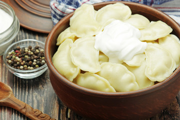 A ceramic bowl with freshly cooked Russian vareniki with mashed potato	