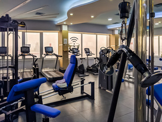 Fototapeta na wymiar Body weights and dumbbells for arms, legs and bodybuilding biceps, triceps and chest, back. Modern gym for training every day.