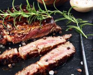 Barbecue Rib Eye Steak on Slate Slab - Dry Aged Wagyu Entrecote Steak and rosemary