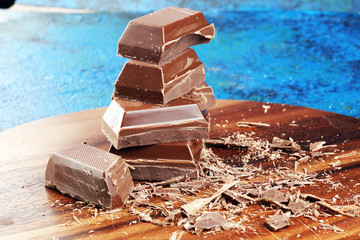 Dark chocolate stack, chips and powder with chocolate bars and block