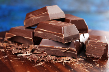Dark chocolate stack, chips and powder with chocolate bars and block