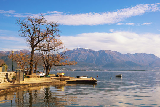 Beautiful winter Mediterranean landscape. Montenegro, view of Kotor Bay near Djenovici village and snow-capped Lovcen mountain