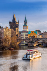 Prague, Czech Republic - Beautiful golden sunset and blue sky at the world famous Charles Bridge (Karluv most) and Old Town Water Tower on a winter afternoon © zgphotography