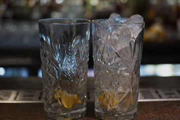 Two glasses one with ice