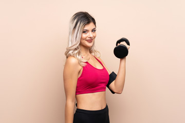 Teenager sport girl over isolated background making weightlifting