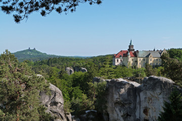 Fototapeta na wymiar Hruba Skala castle on sandstone rock and Trosky castle on background, Bohemian Paradise, Czech Republic