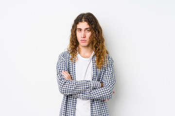 Young long hair man posing isolated unhappy looking in camera with sarcastic expression.