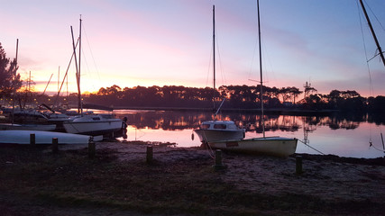 harbour boat in lacanau lake at sunset in France
