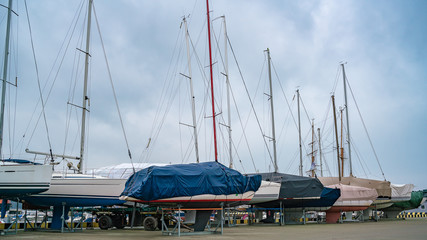 Yachts stand on the pier for the winter.