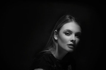 black and white portrait of fashion beautiful model, brunette girl with freckles in studio, close up, young woman head shot 