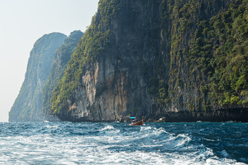 Tropical island view in open sea with touristic boat