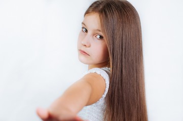 Naklejka premium Little girl face portrait in Girl child brush hair in fashionable dress
