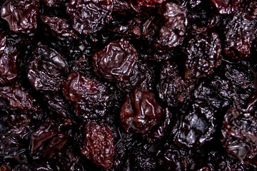 background of dark raisins. close up. dried grapes.