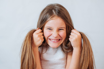 Fototapeta premium Little girl face portrait in Girl child brush hair in fashionable dress